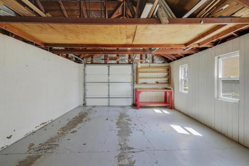 Garage with automatic opener, 2 daylight windows and space for a work station or extra storage.