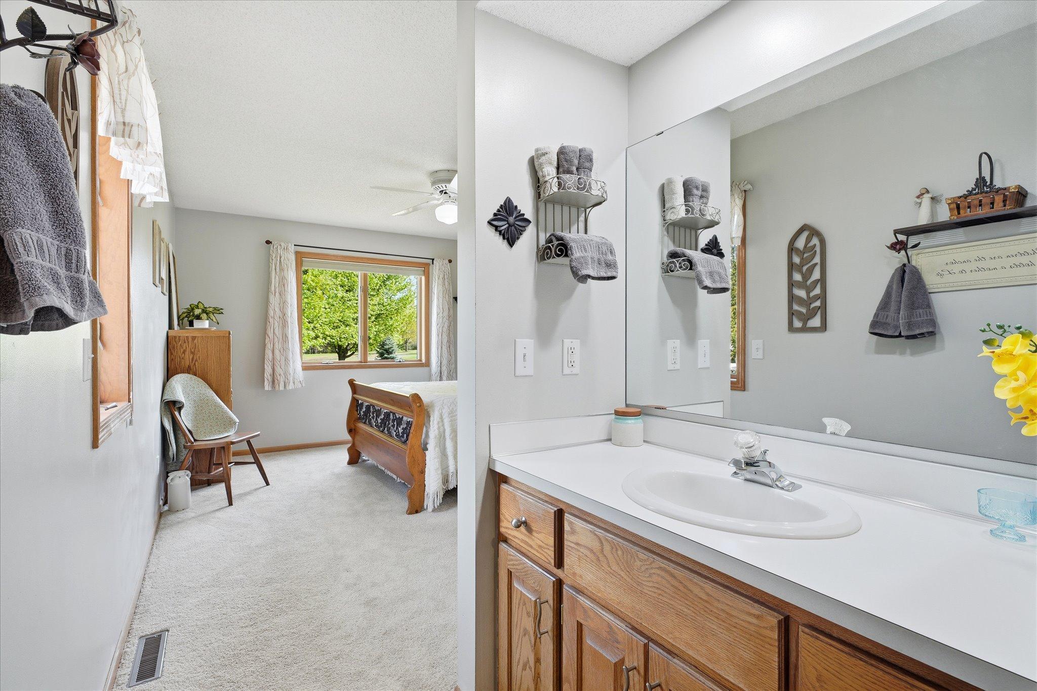 The built-in oak vanity is in a different room than the toiler and shower are.