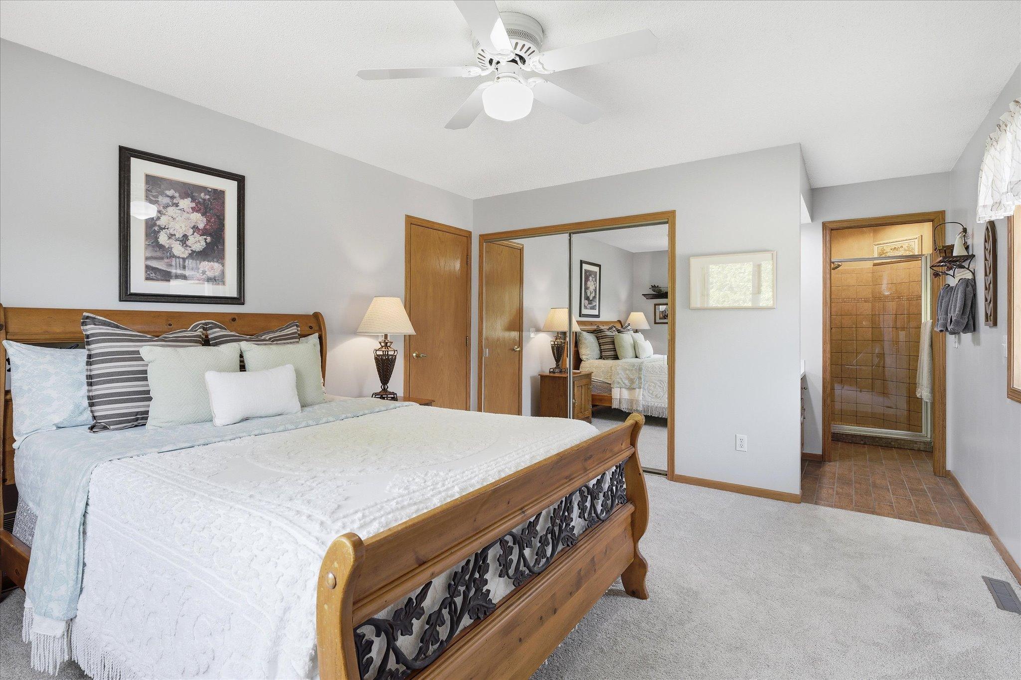 The closet doors are mirrors, and the private primary 3/4 bath is on the right side of this image.