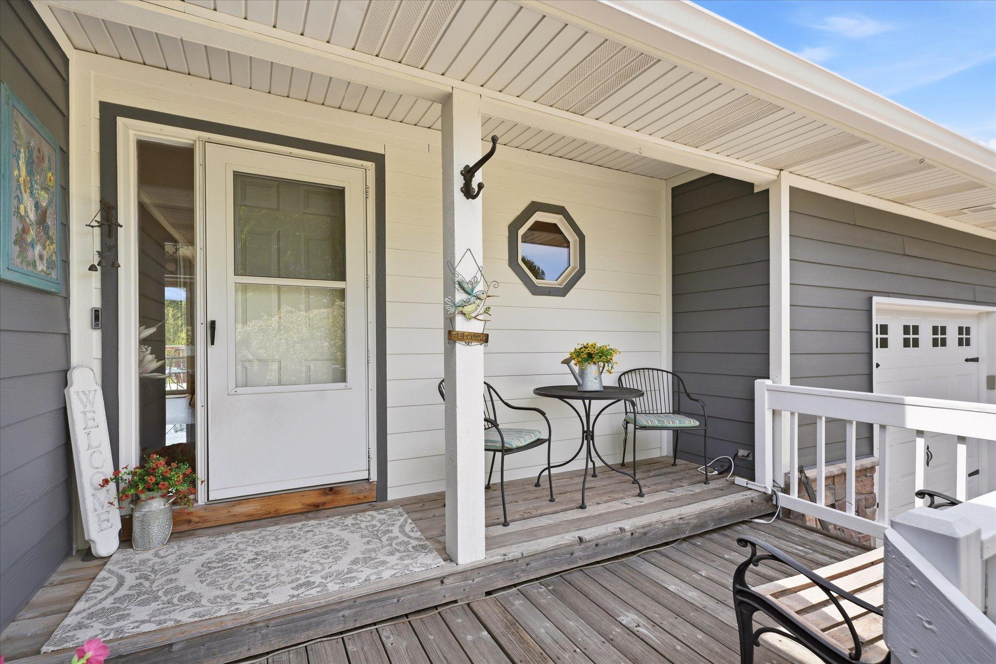 The front porch greets you with a Vivint video doorbell, and plenty of space for seating!