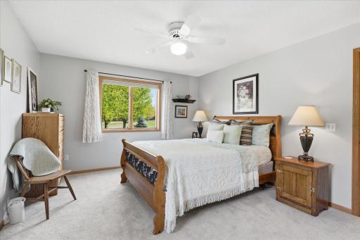 The neutral paint, the ceiling fan and the Andersen window rounds out this beautiful room.