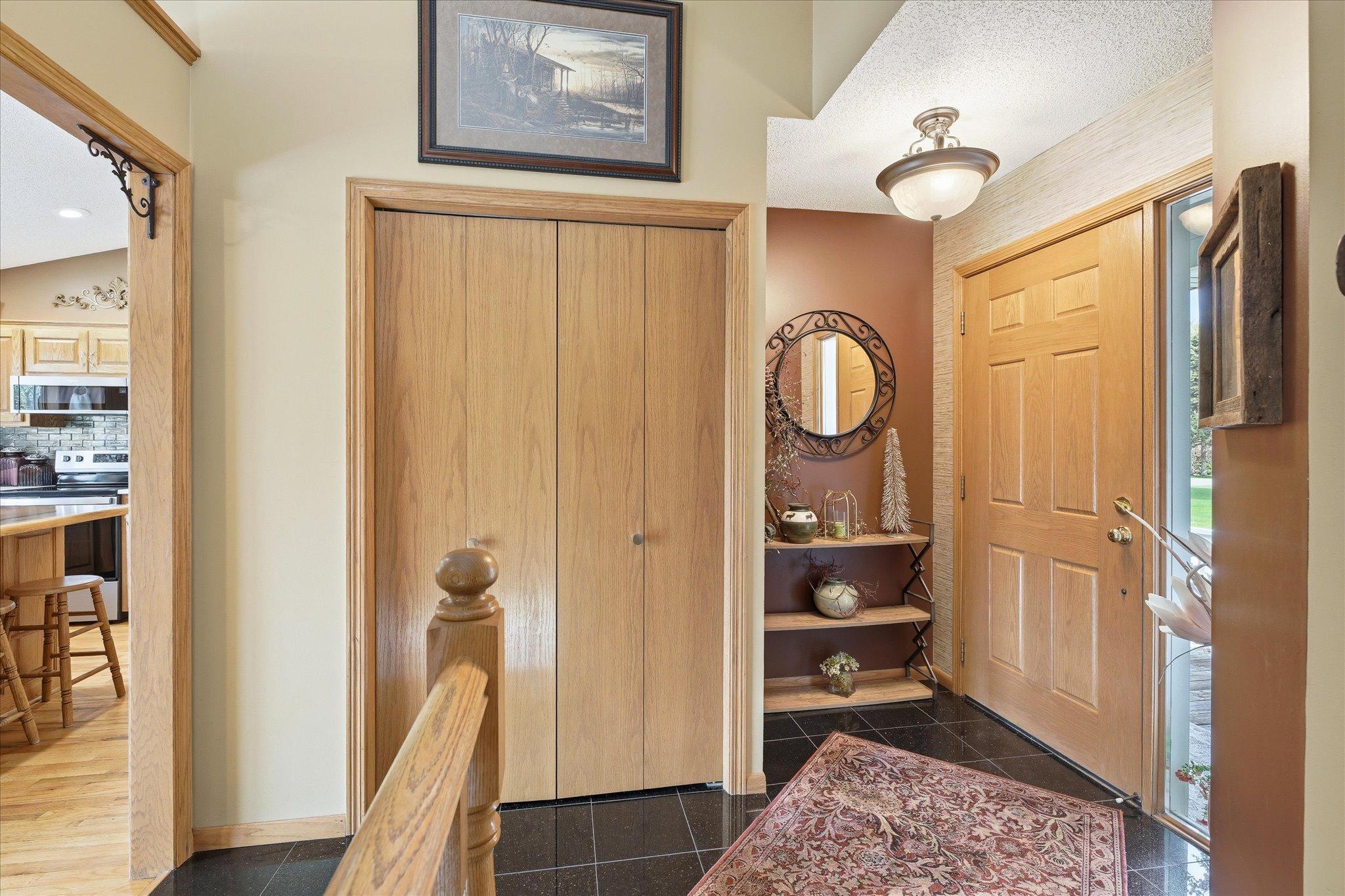 At last, we enter the house! The entryway features two coat closets, tile flooring and modern, neutral paint.