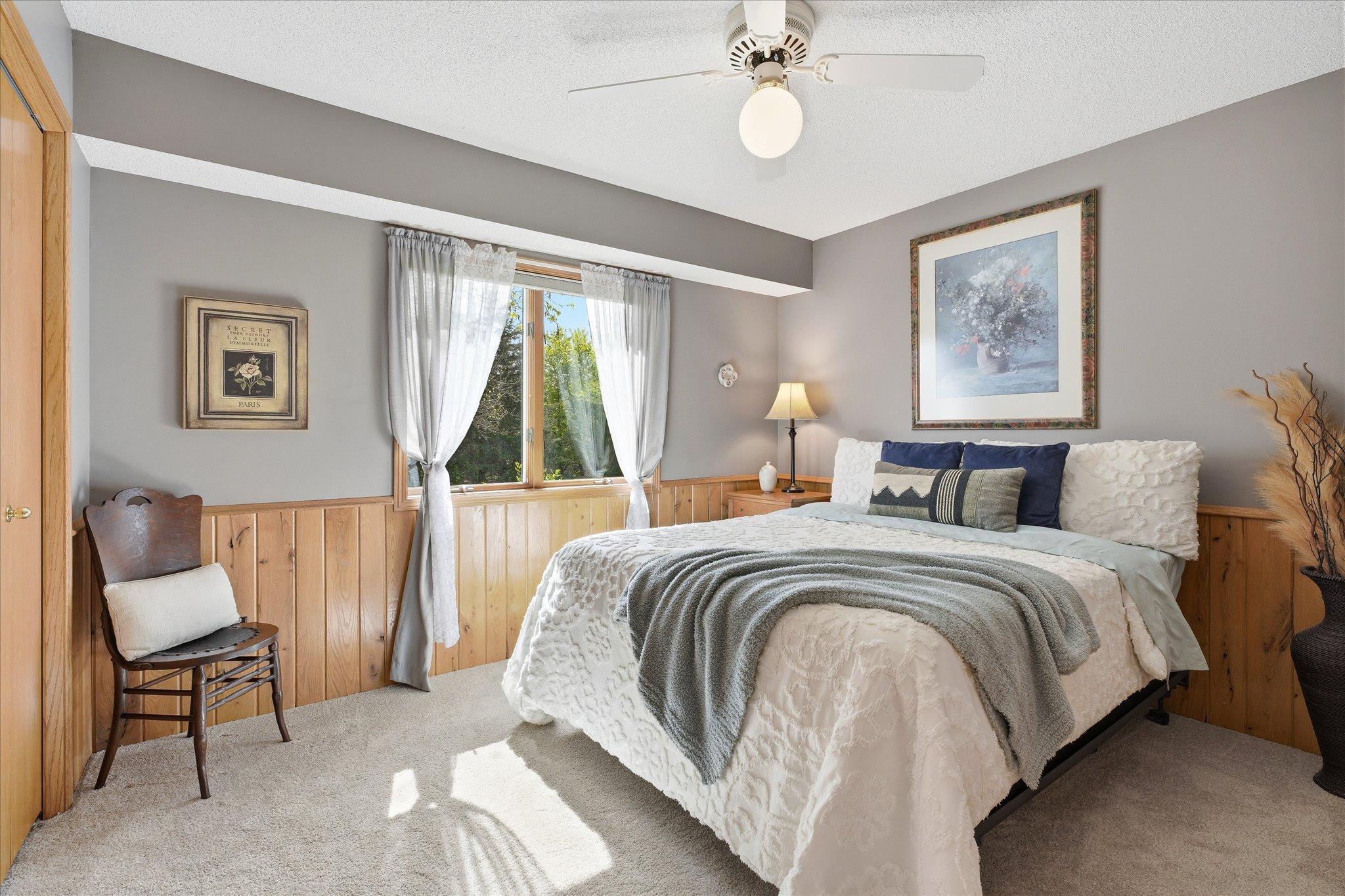This bedroom also has new carpet, a ceiling fan and oak wainscotting.