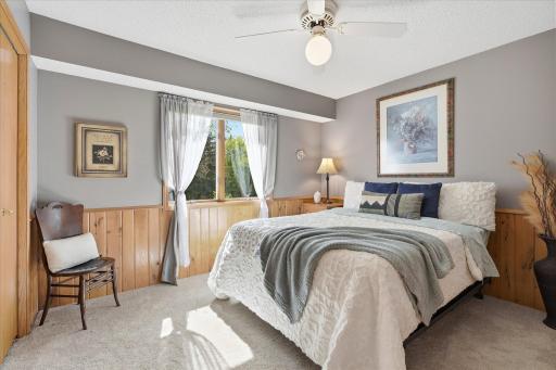This bedroom also has new carpet, a ceiling fan and oak wainscotting.