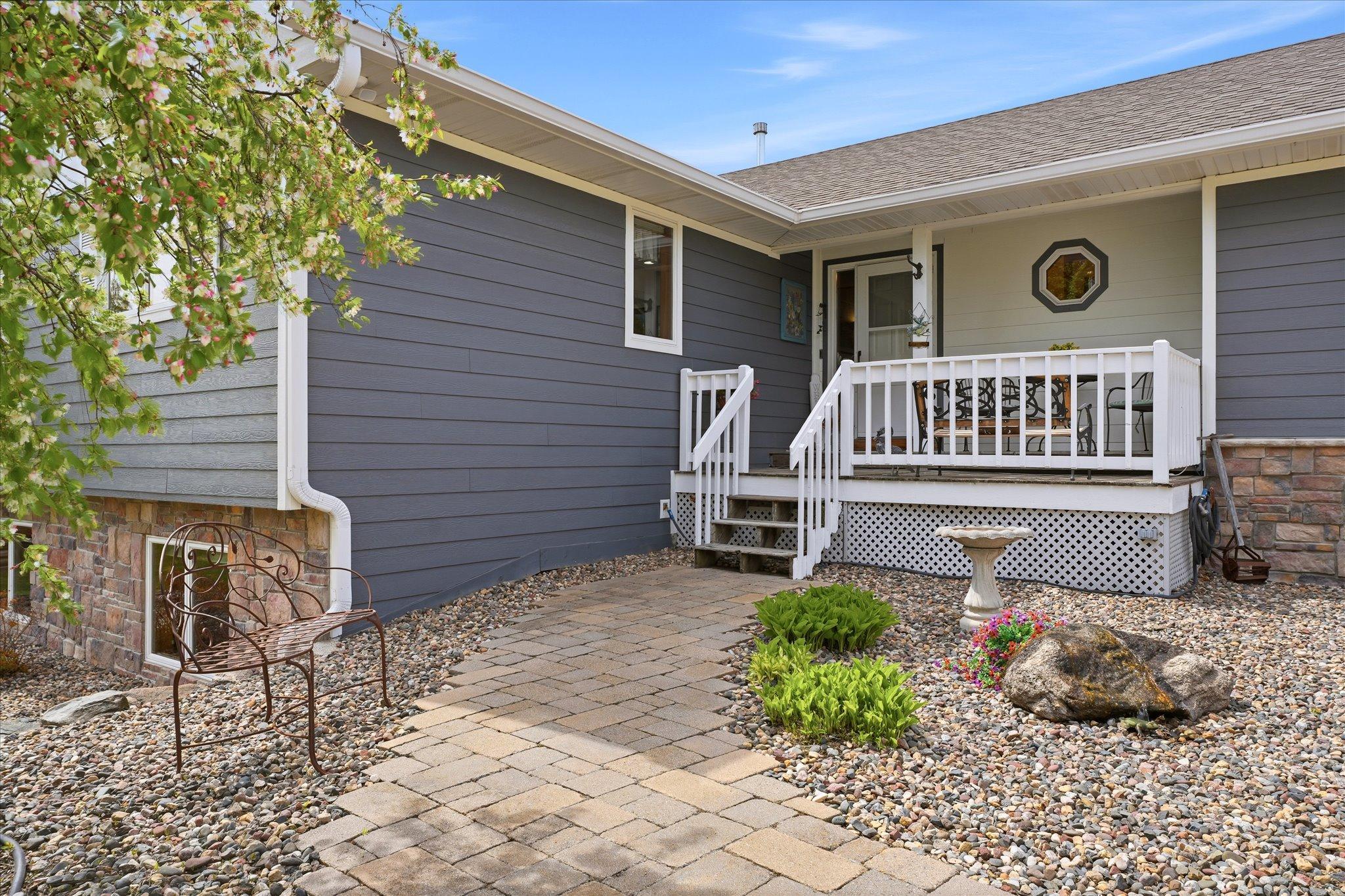 The paver walkway leads to the beautiful front porch. That fiber cement & stone siding, those roof shingles, those gutters and that soffit & fascia are all just two years young.