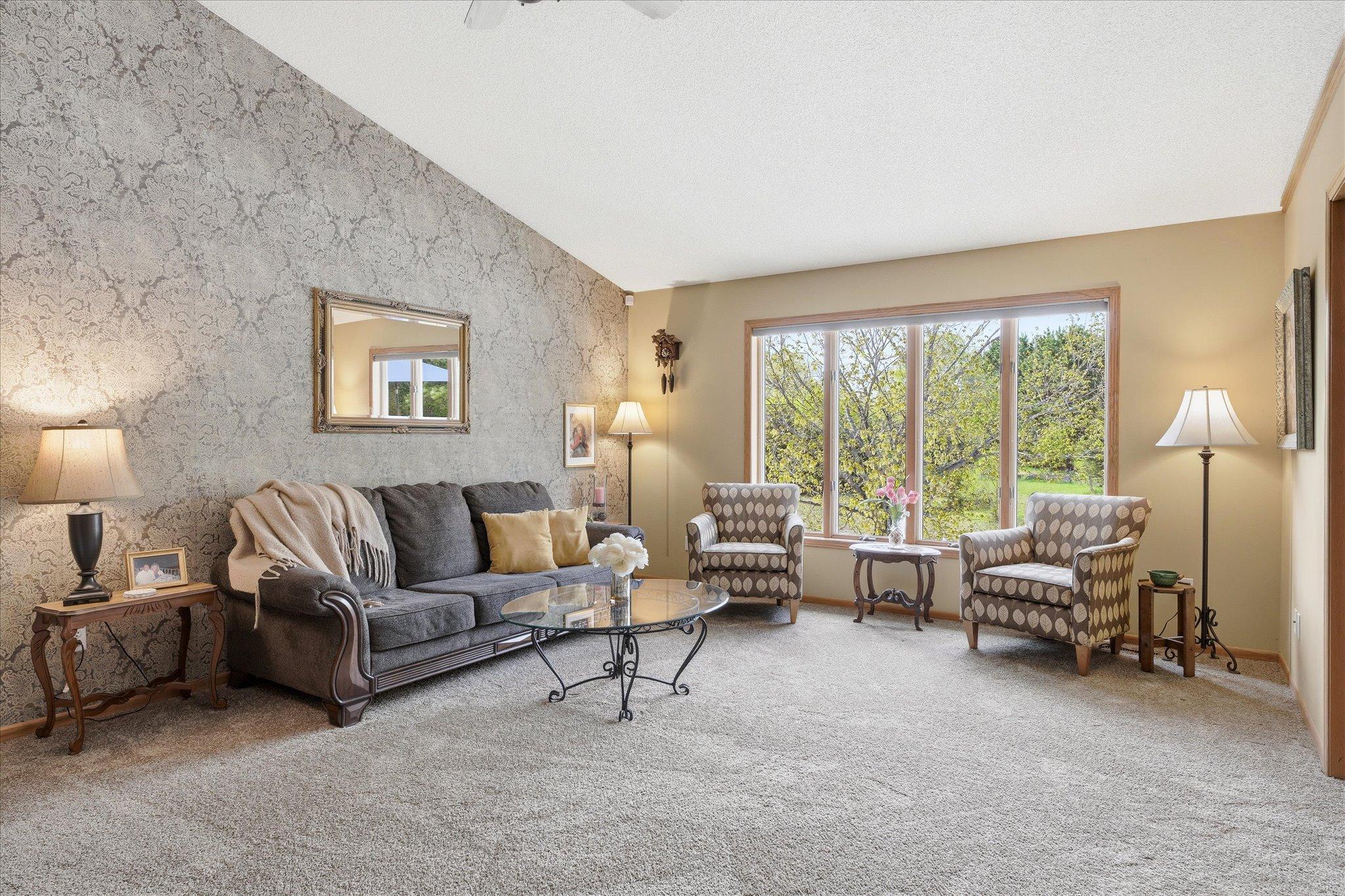 This living room is large & beautiful, and connected to the kitchen, making for great entertaining!
