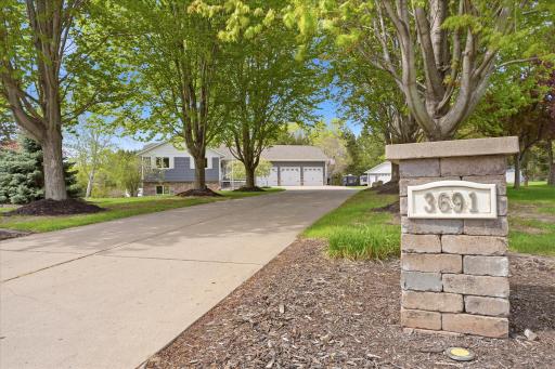 The maple-tree-lined driveway begins with a beautiful paver stone address monument, just to be sure you're in the right place.