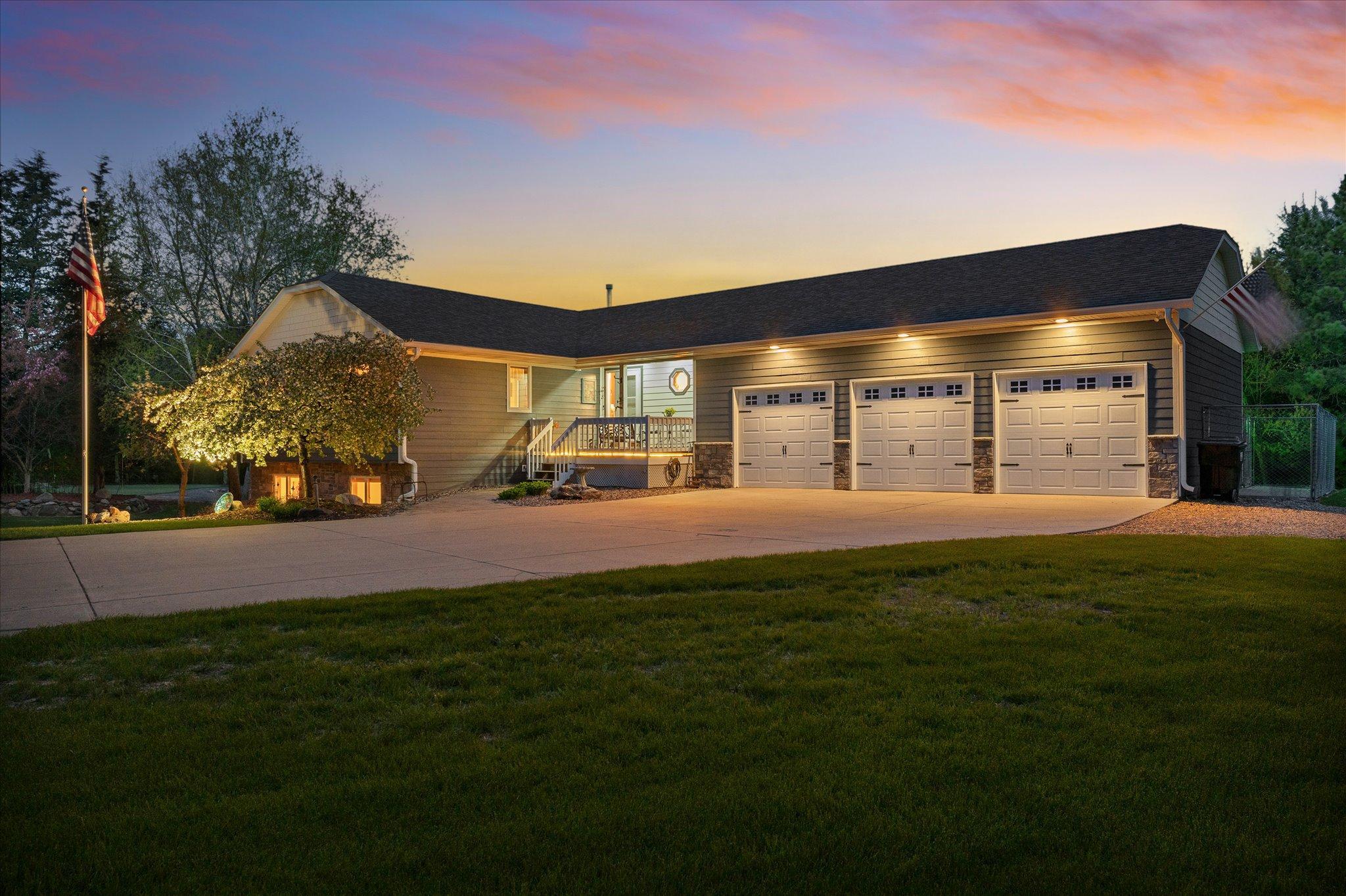 The soffit lighting above the garage doors and the front porch light provide a welcoming ambience.