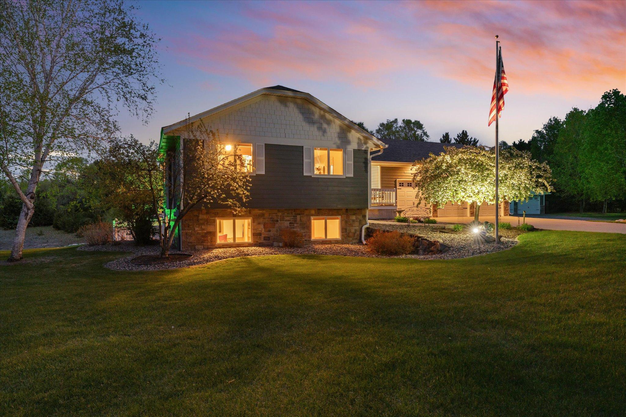 The trees and the flagpole headline a landscape that's easy to maintain and be proud of.