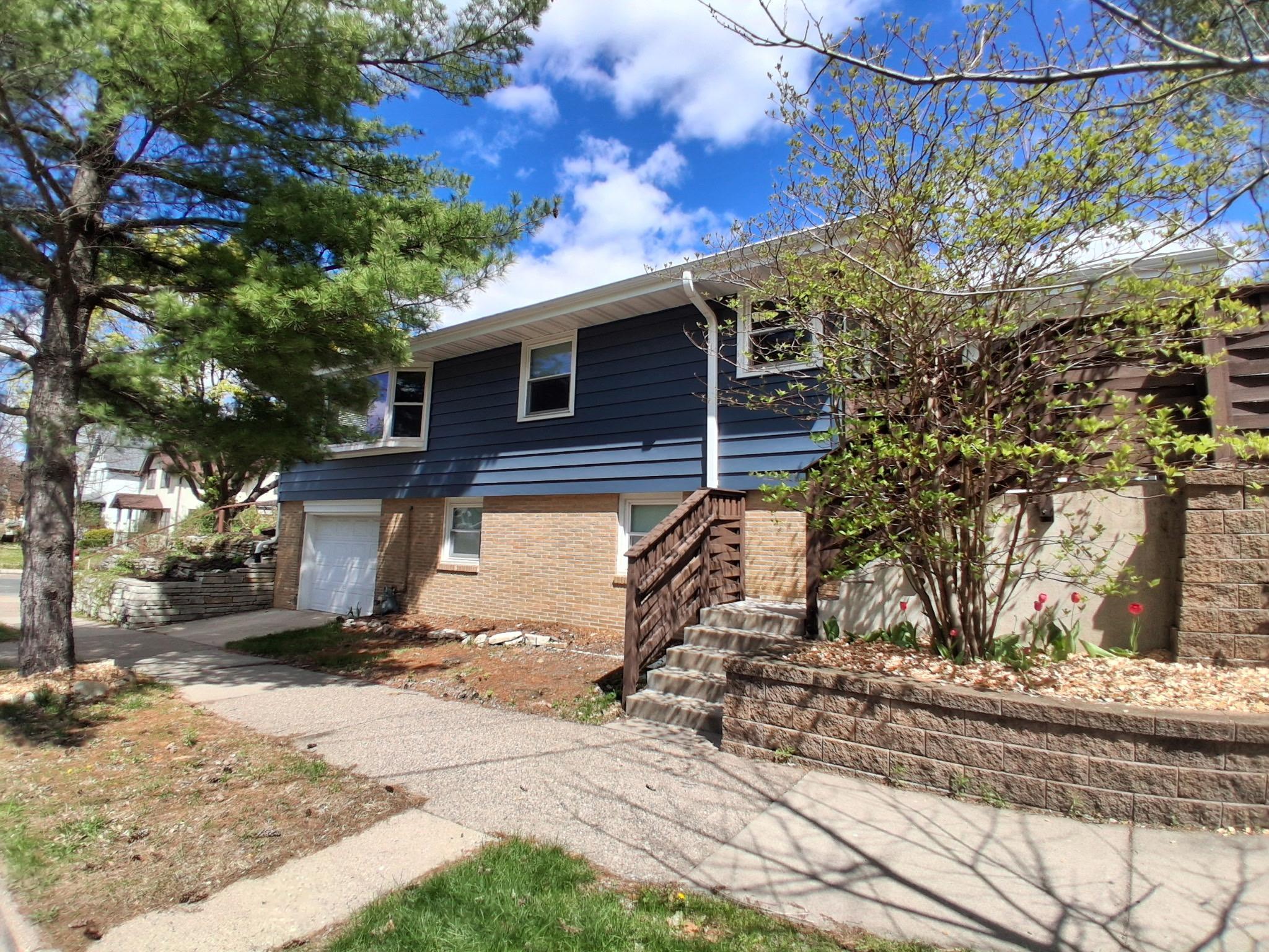 Attached tuck-under garage with entrance to home. Steps pictured lead you to the gate to your private back yard and kitchen entrance with grilling area