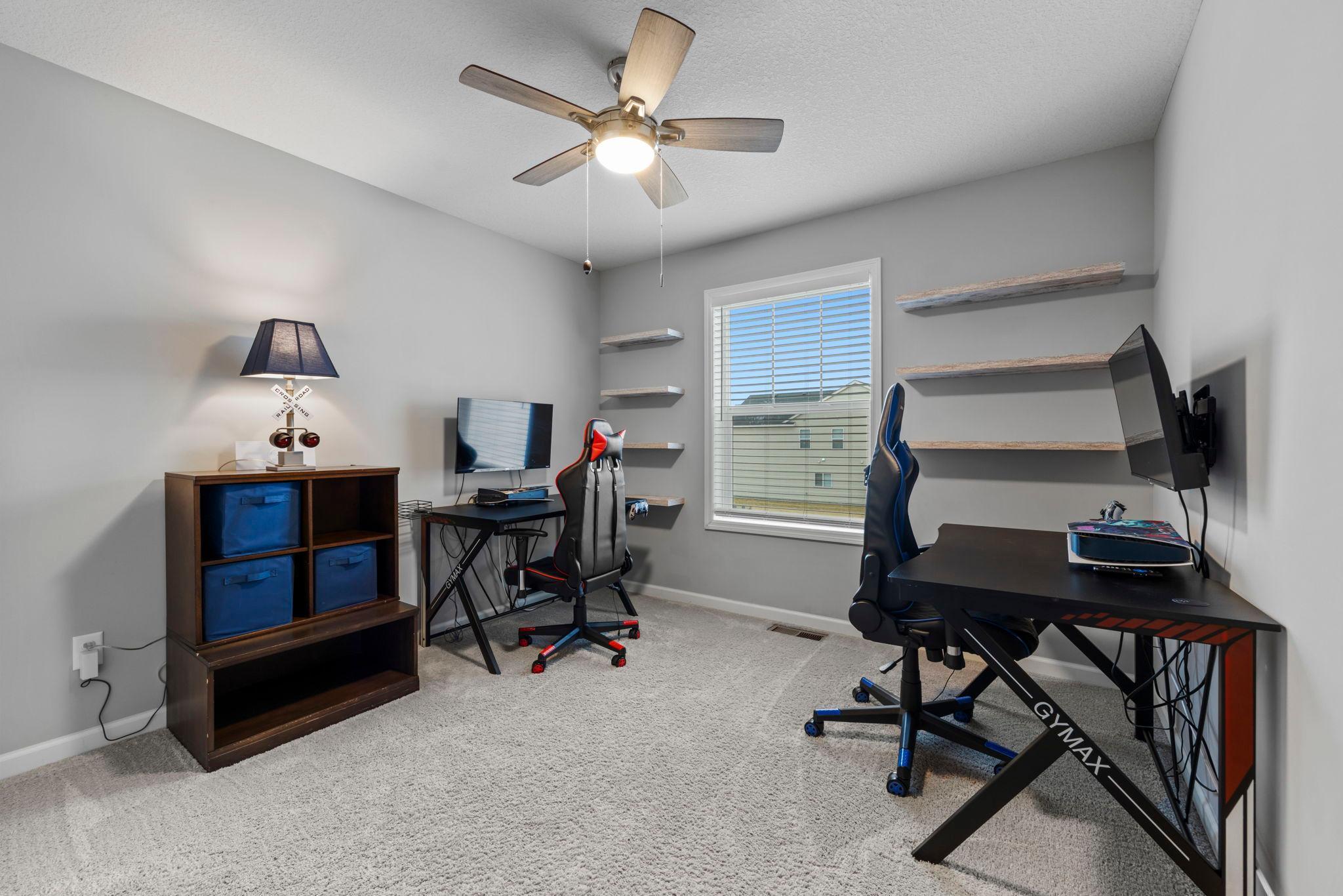 4th Bedroom Upstairs with Built-in shelves, custom window treatments, and ceiling fan
