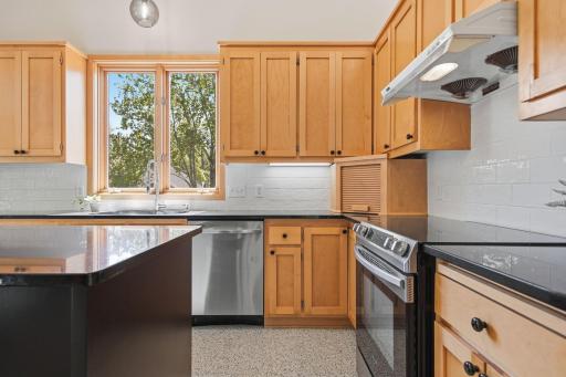 Updated backsplash pairs beautifully with the warm wood cabinetry.