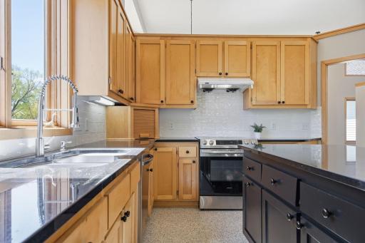 A well-designed cooking area with vent hood and generous prep space.