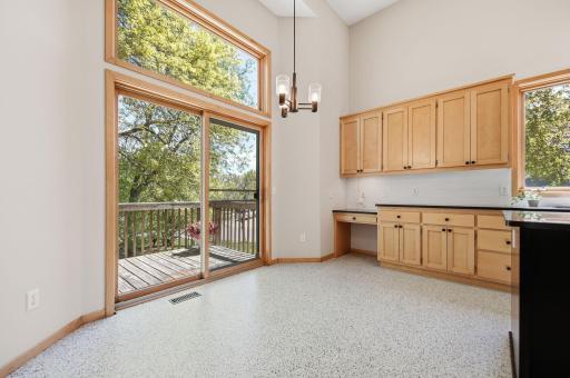 The dining area offers access to the deck, perfect for outdoor dining and grilling.