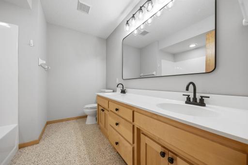 Full upper-level bathroom with double sink vanity.