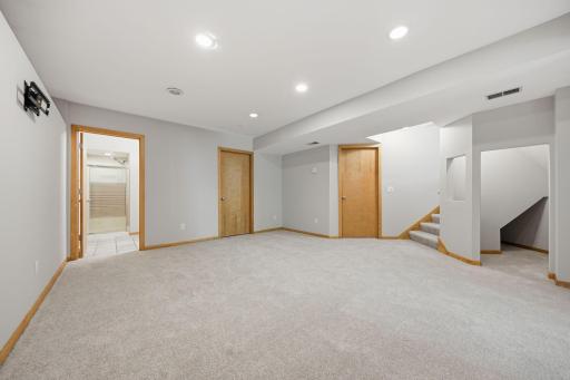The lower level provides additional living space, including a bedroom, bathroom, and recreation area.
