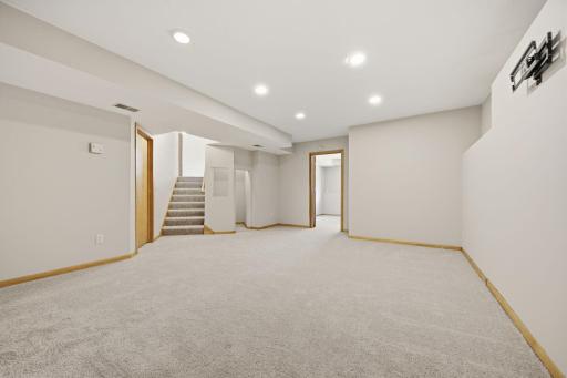 A cozy nook under the stairs adds charm, along with access to the fifth bedroom.