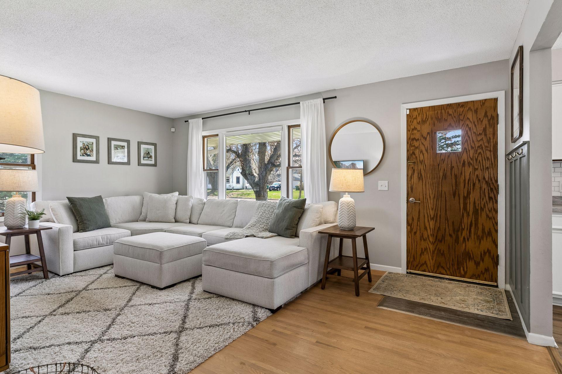 Step into the living room featuring beautifully refinished hardwood floors (2020).