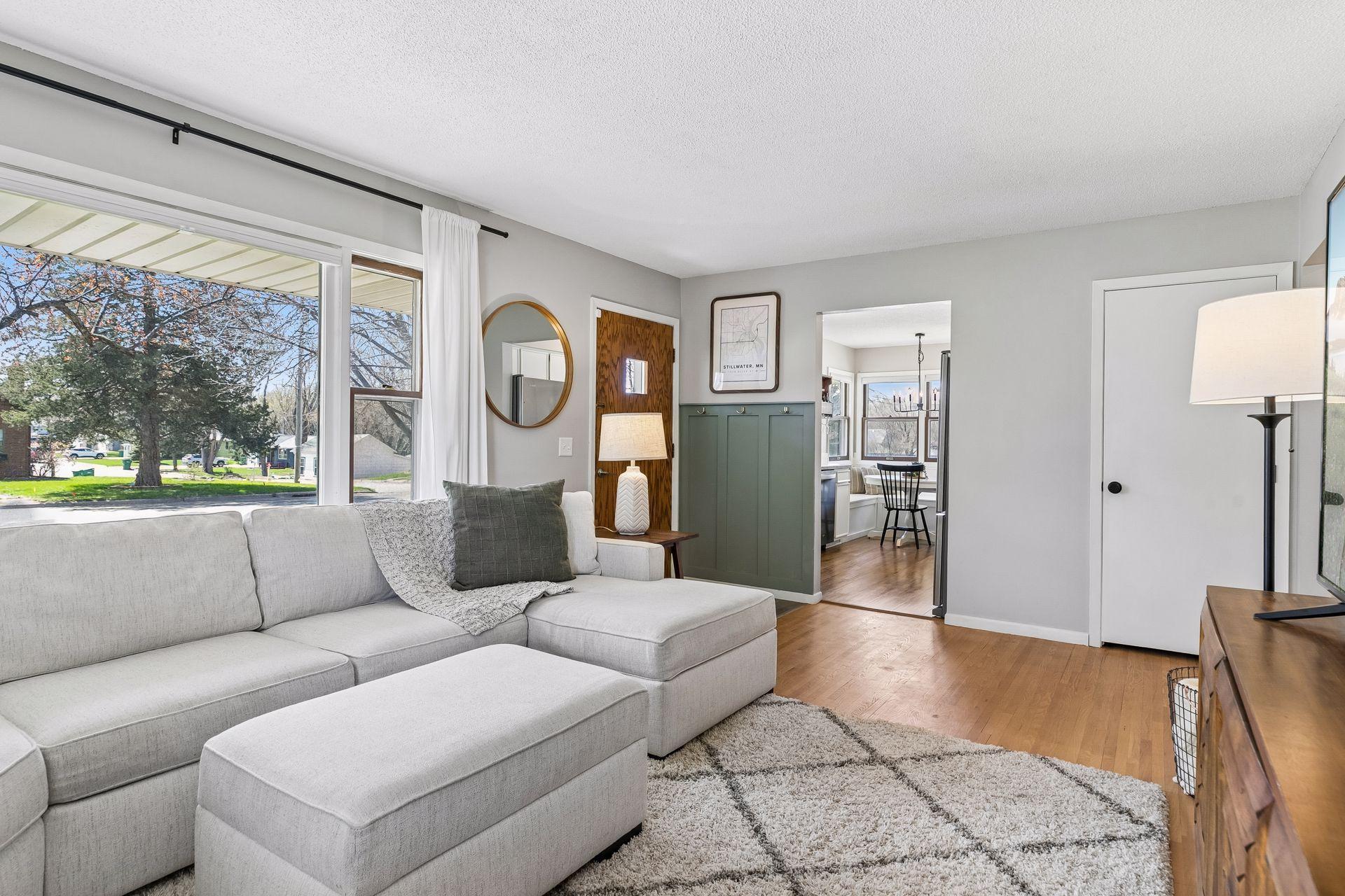 Another angle of the living room highlighting charming updates, including the stylish accent wall with hooks.