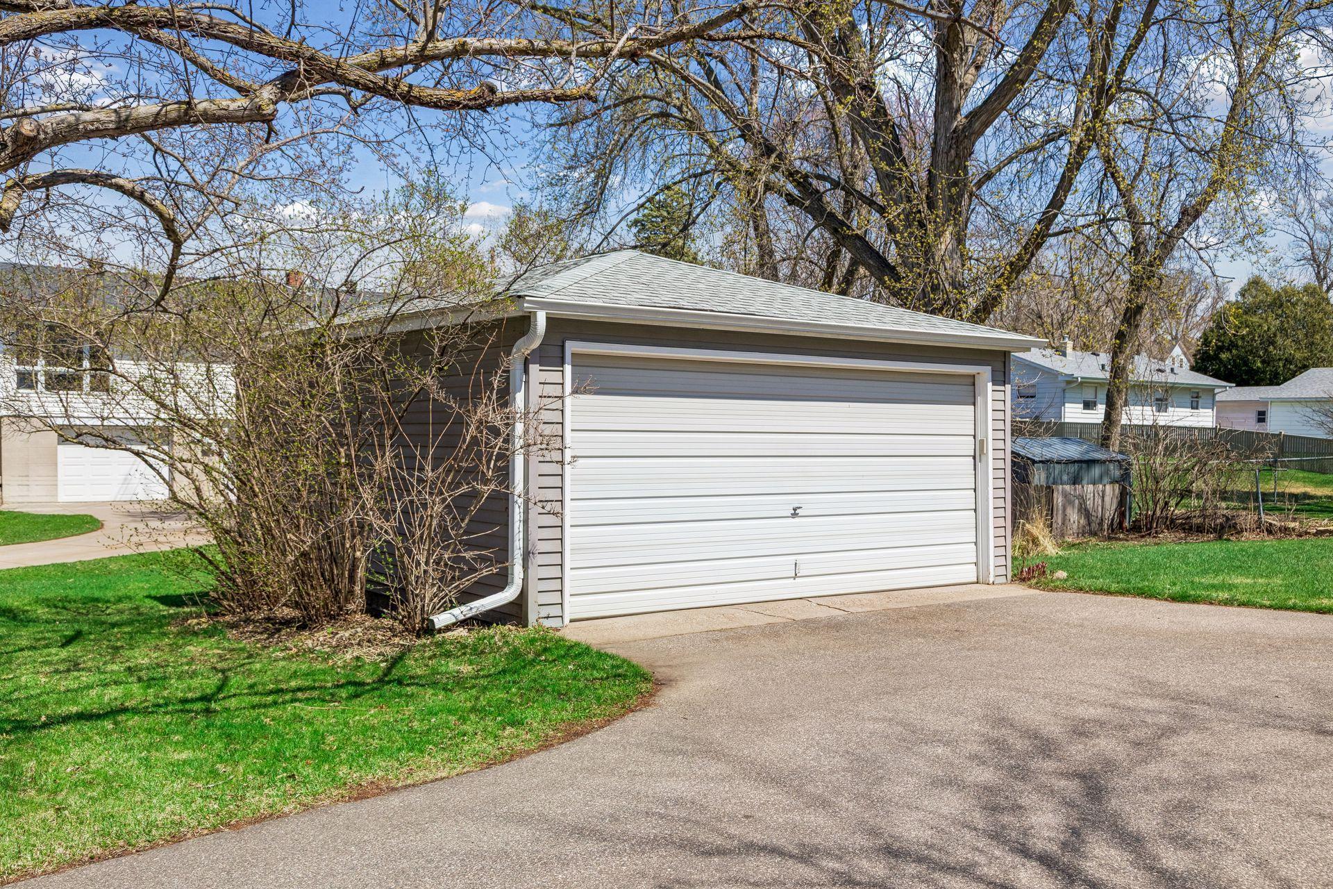 Detached 2-car garage with a newer driveway for added convenience and functionality.