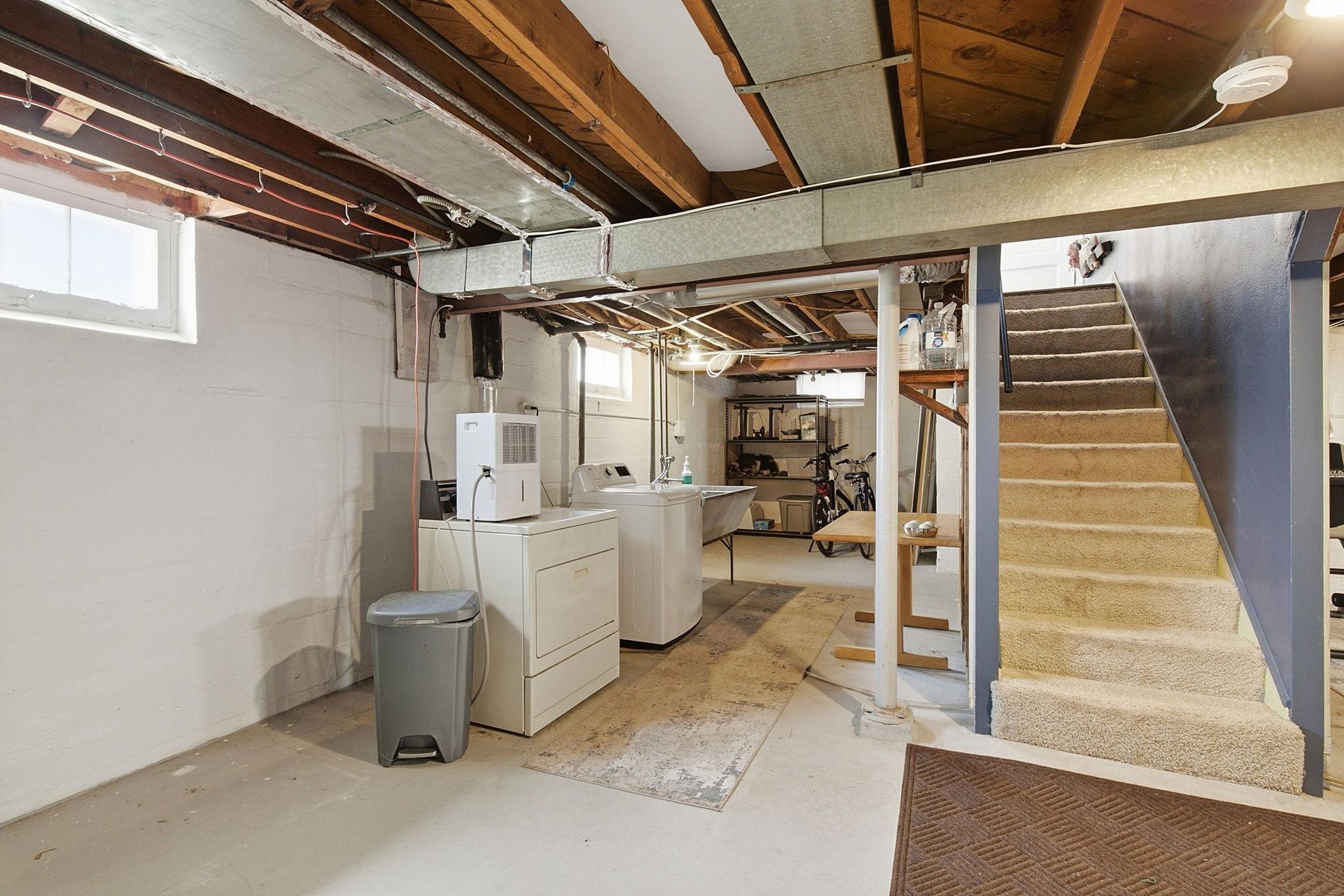 Open laundry space with storage.