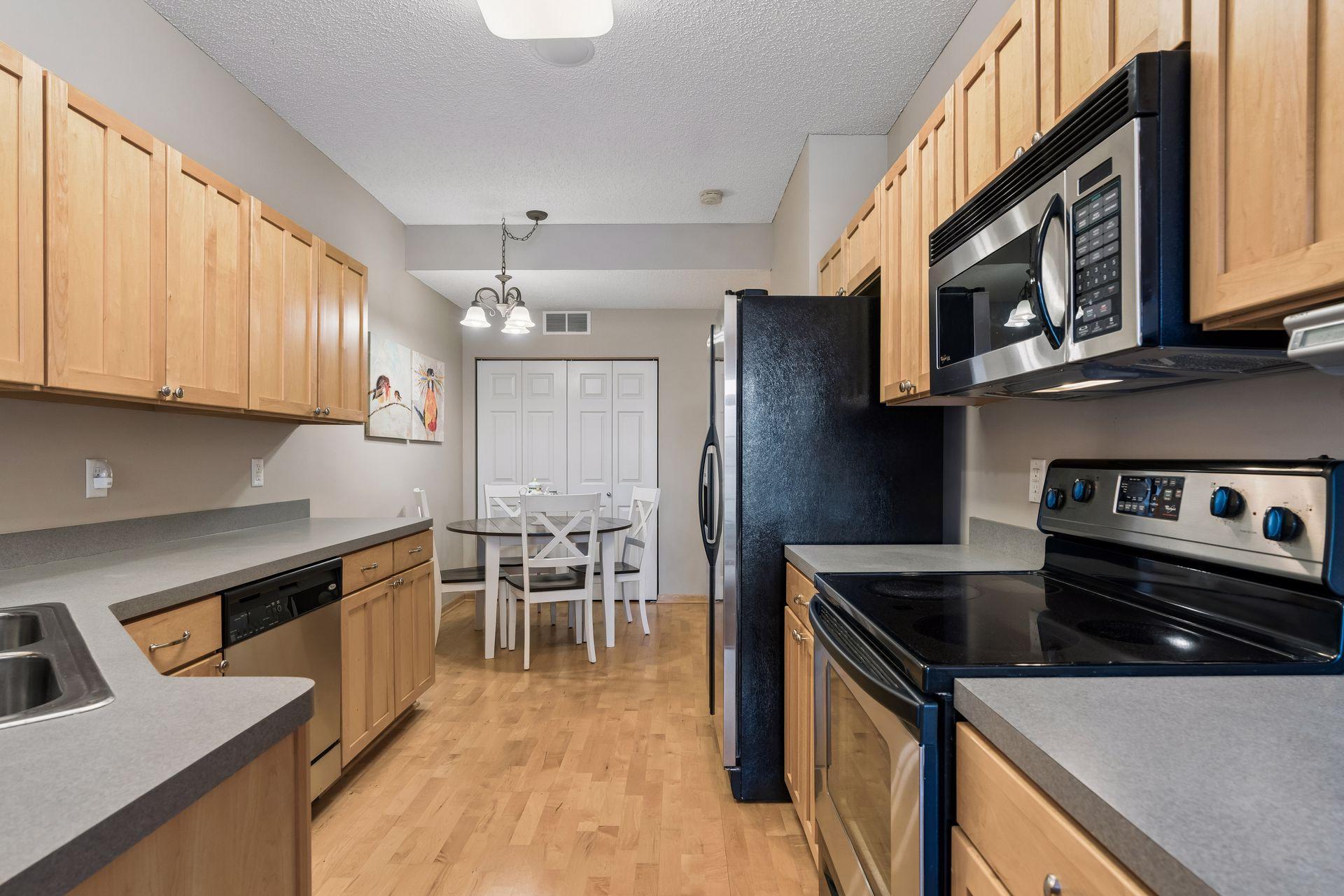 Sparkling kitchen with upgraded Maple cabinetry, wood laminate flooring and stainless appliances.