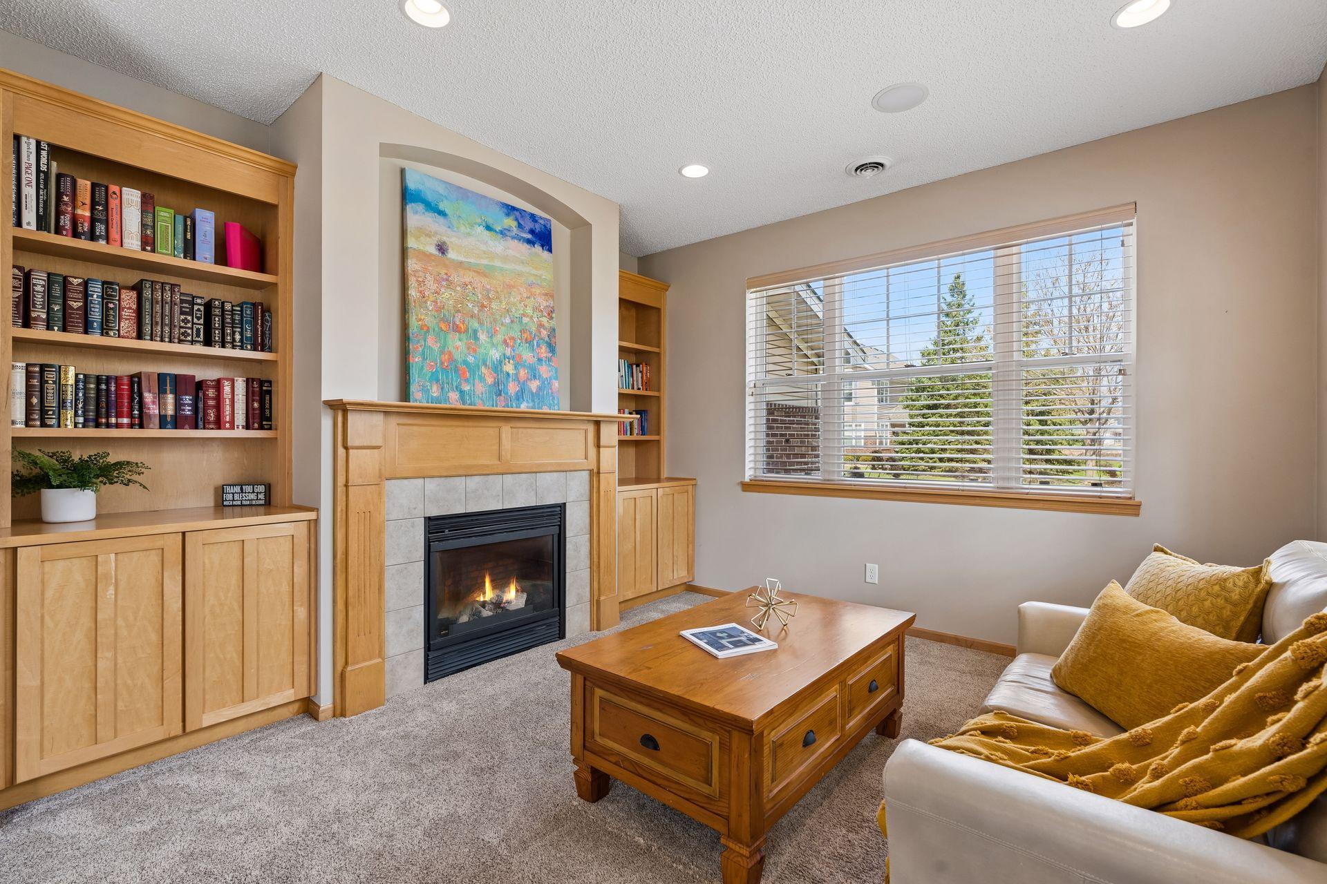 Gorgeous gas burning fireplace with a custom surround, flanked by stunning built-in's.