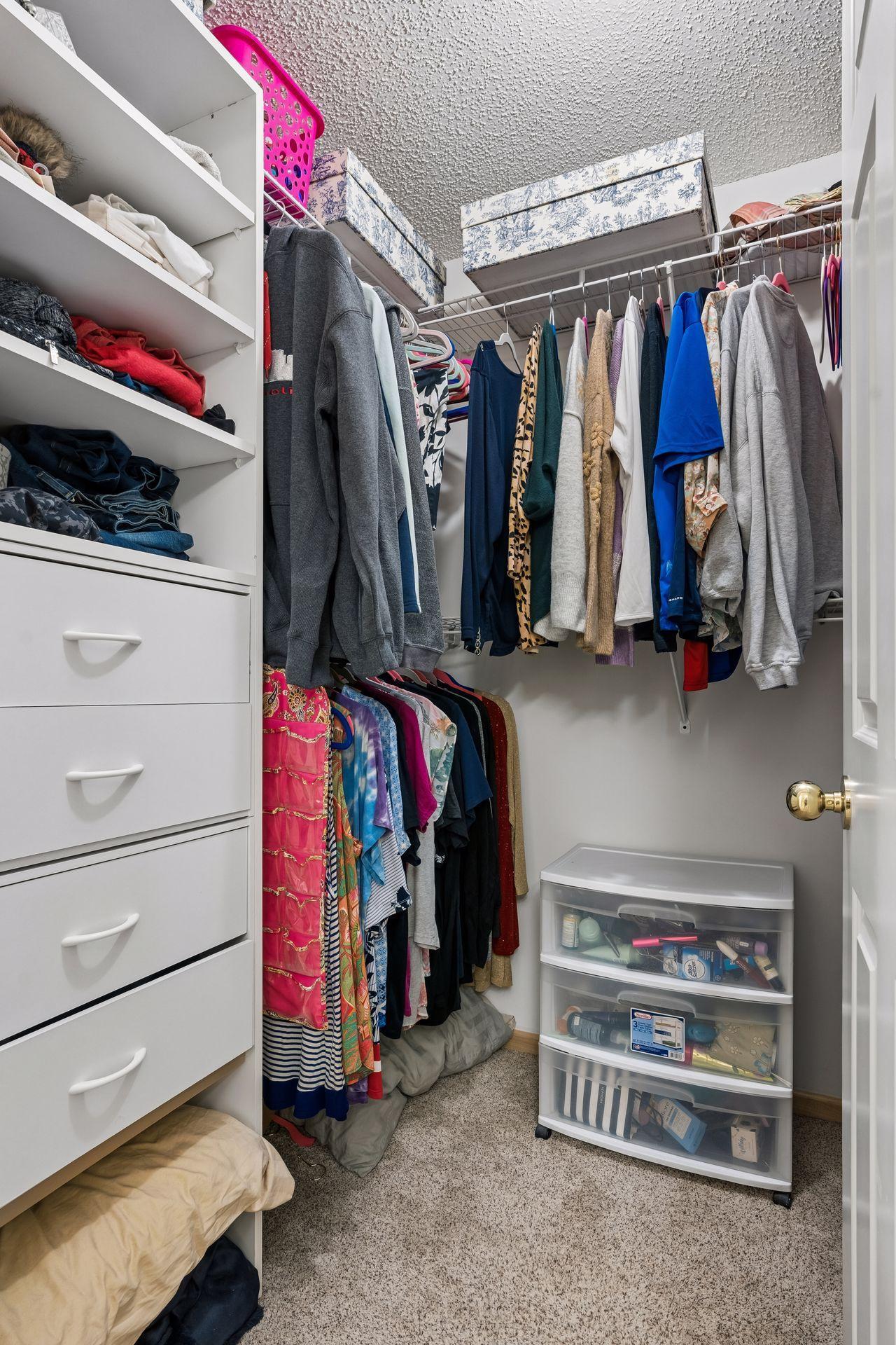 Walk-in closet located within the primary suite bath.