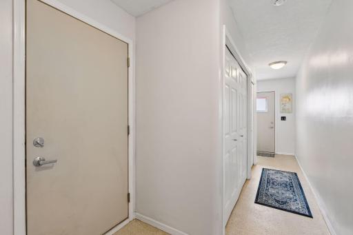 Internal door to garage and hallway to back door for guest entering from back parking area.