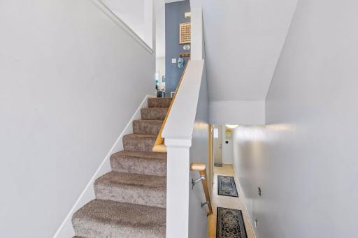 View from front door landing facing lower level access to backdoor, and the stair to the left leads to main floor.
