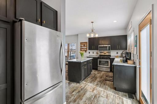 View from extension of kitchen with refrigerator, additional storage, and laundry.