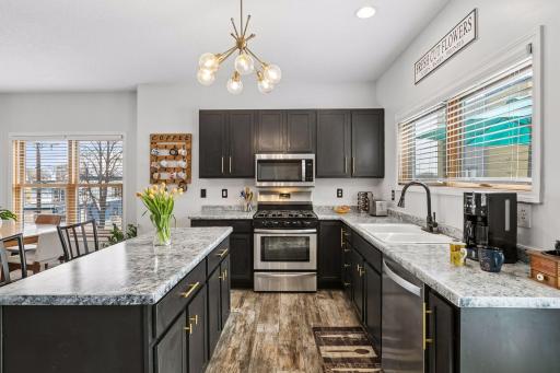 Stainless steel appliances, and modern gold finishes...make for a nice design statement!