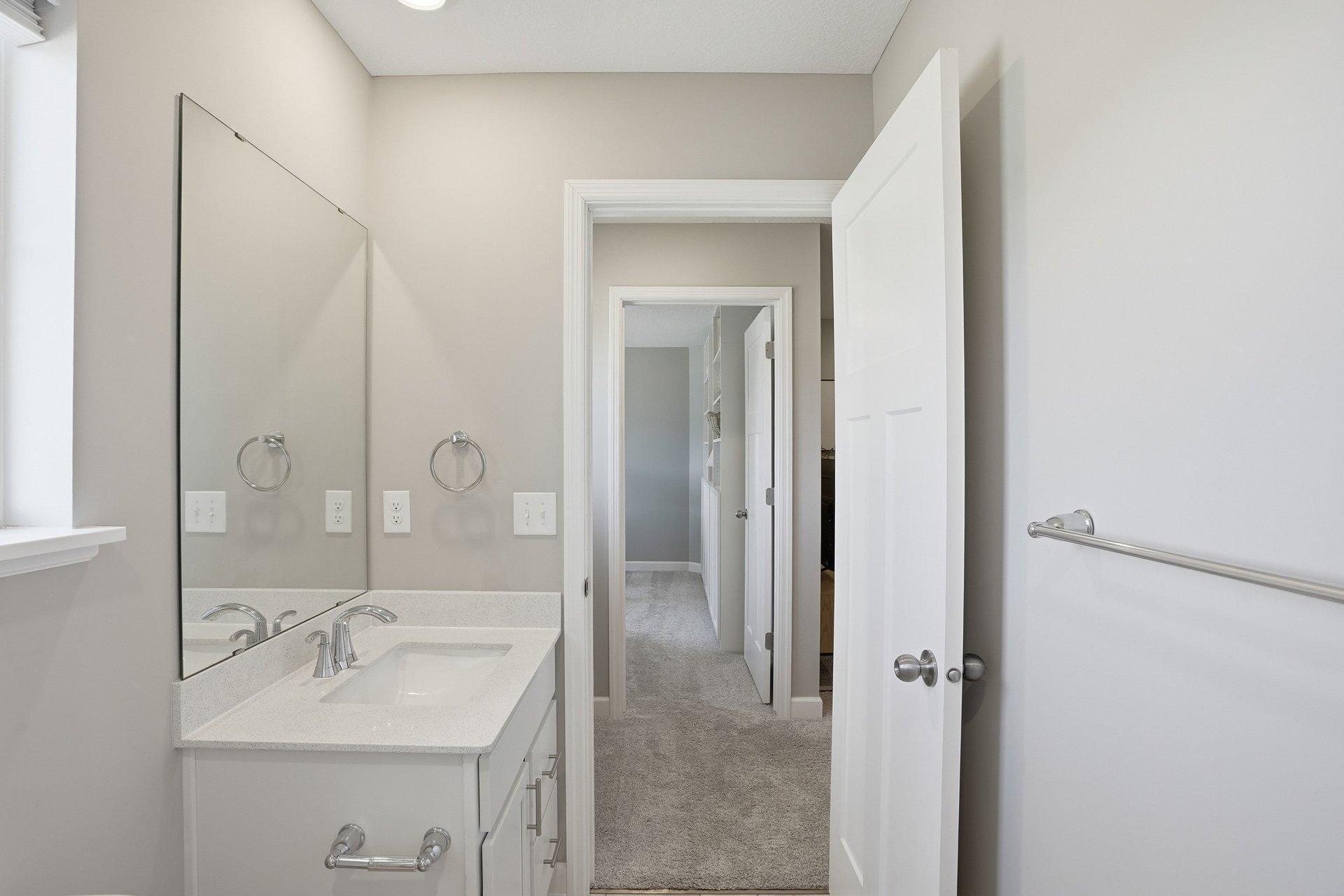 Full hall bathroom with shower/tub combo for children or guests.