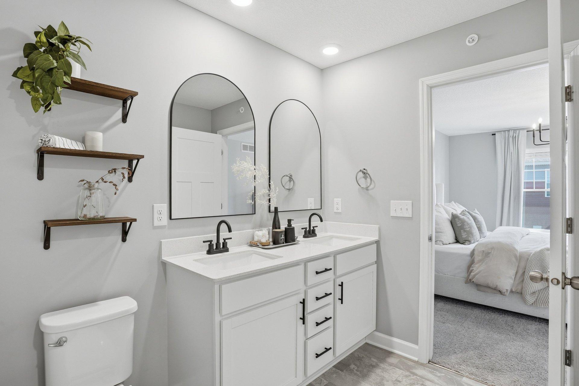 Primary ensuite has double sinks, walk-in shower and fresh black fixtures including new mirrors.
