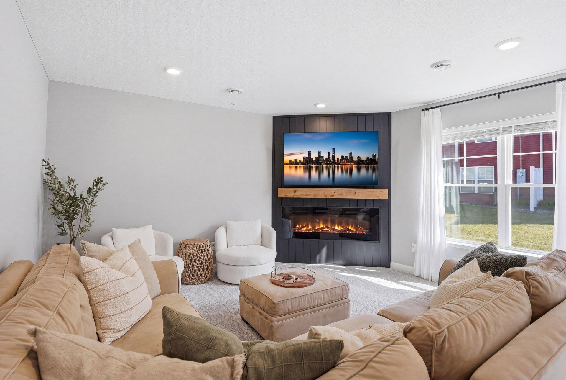 Main level family room features custom shiplap wall and mantle over luxe fireplace.