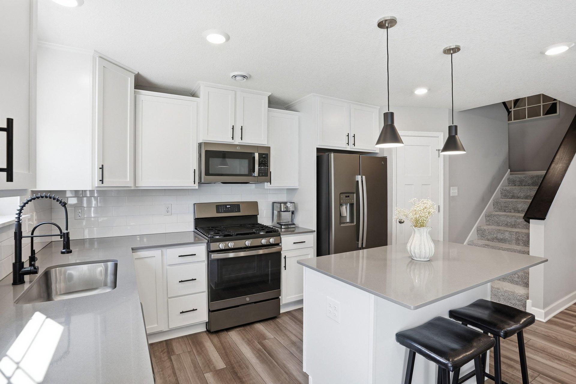 Updated kitchen faucet, knobs/pulls and lighting.