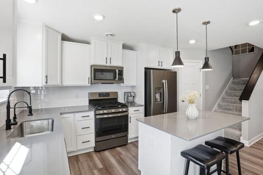 Updated kitchen faucet, knobs/pulls and lighting.