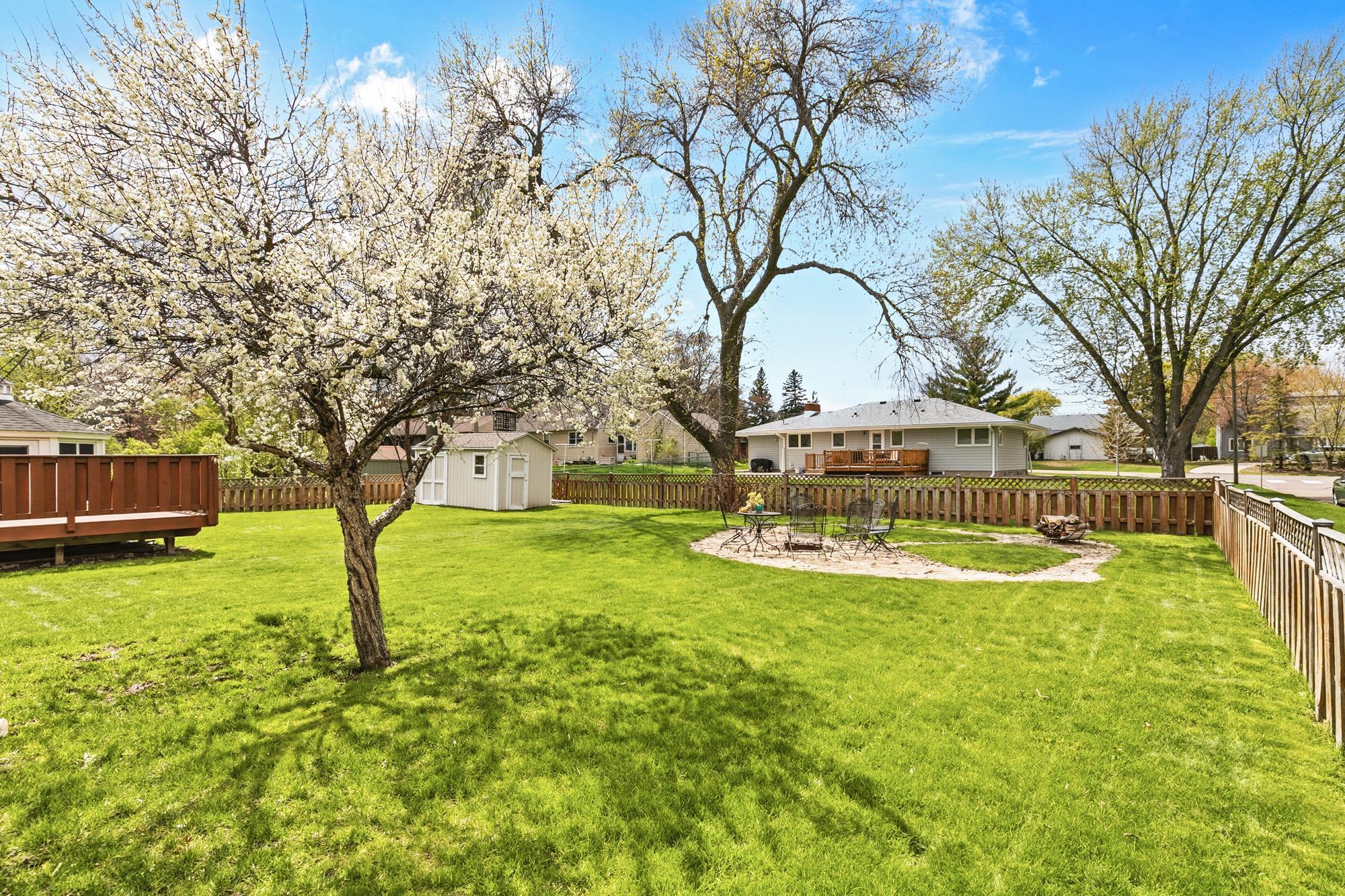 The backyard is fenced in and comes with many backyard necessities including a fire pit entertainment area