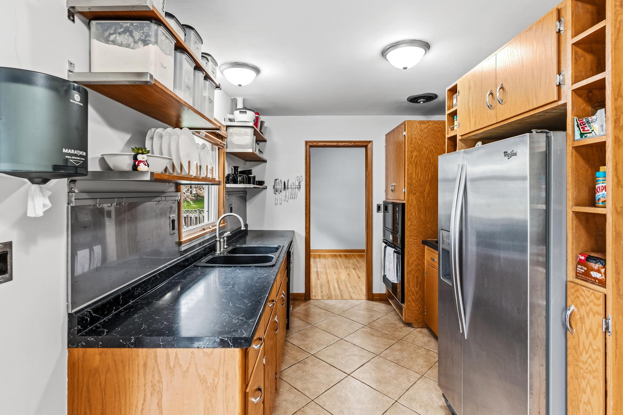 A sleek and open cabinet kitchen design is stylish and functional. Most of the appliance are 2020 or newer.