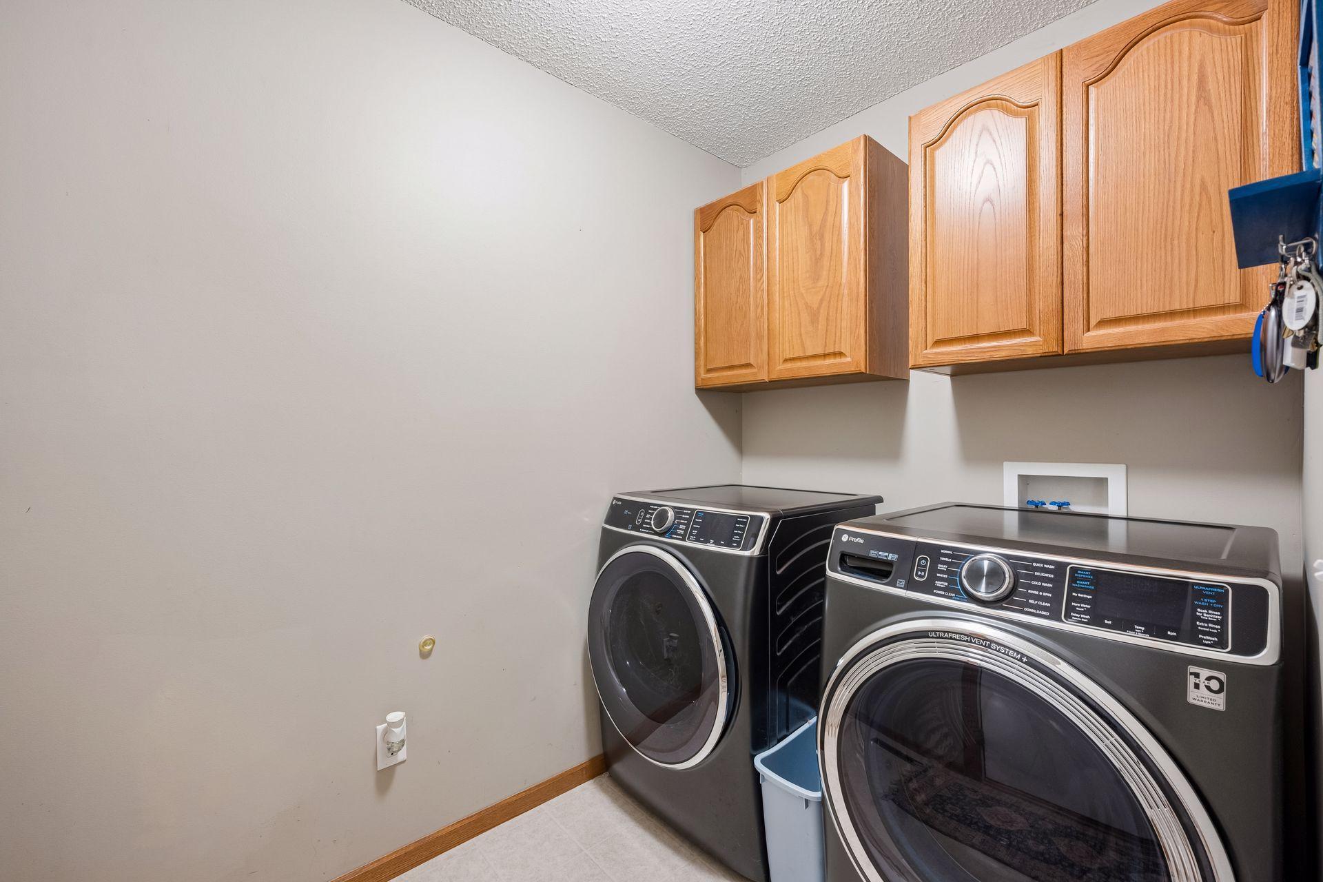 Efficient laundry area with GE High Capacity washer & dryer (2024)