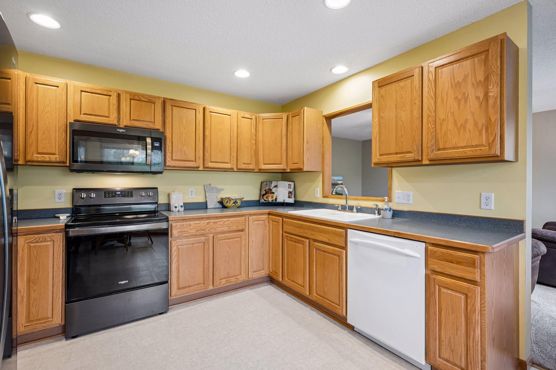Opening at the sink allows great sight lines to family room. Doorway from kitchen to family room allows easy flow from one room to another.