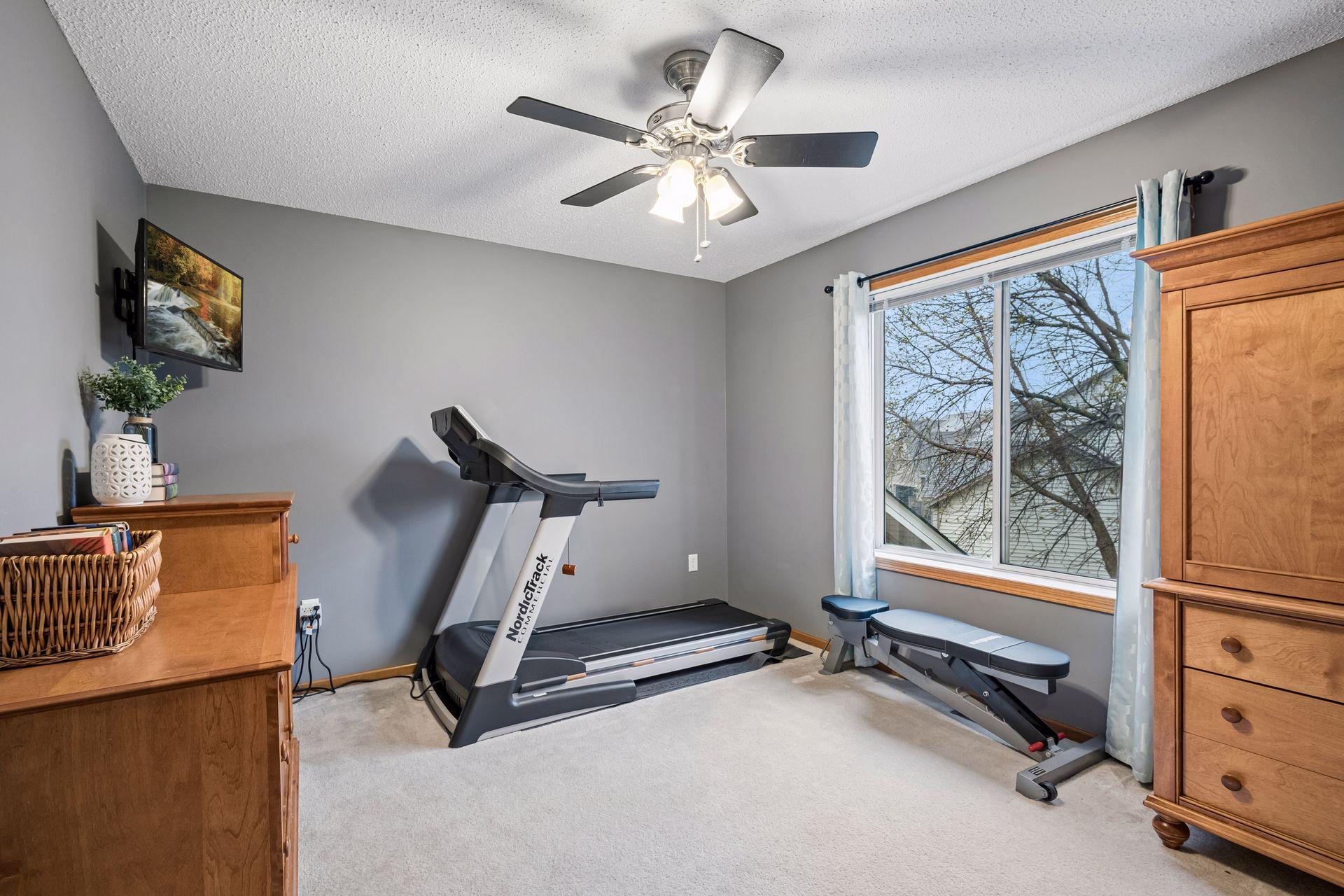 Bedroom #3 currently being used for a home gym.