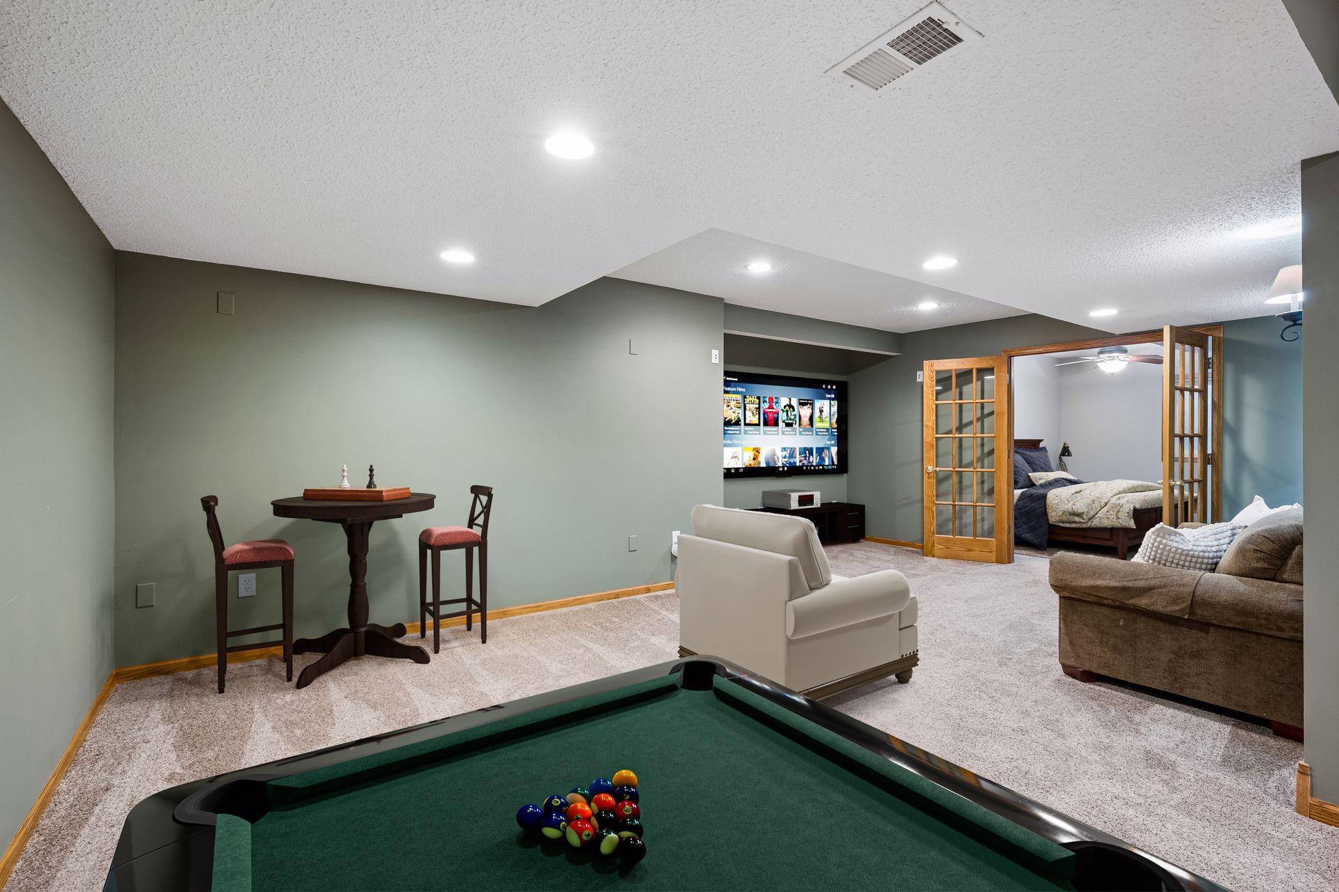 Lower level has been virtually staged. French doors lead to Bedroom #5.