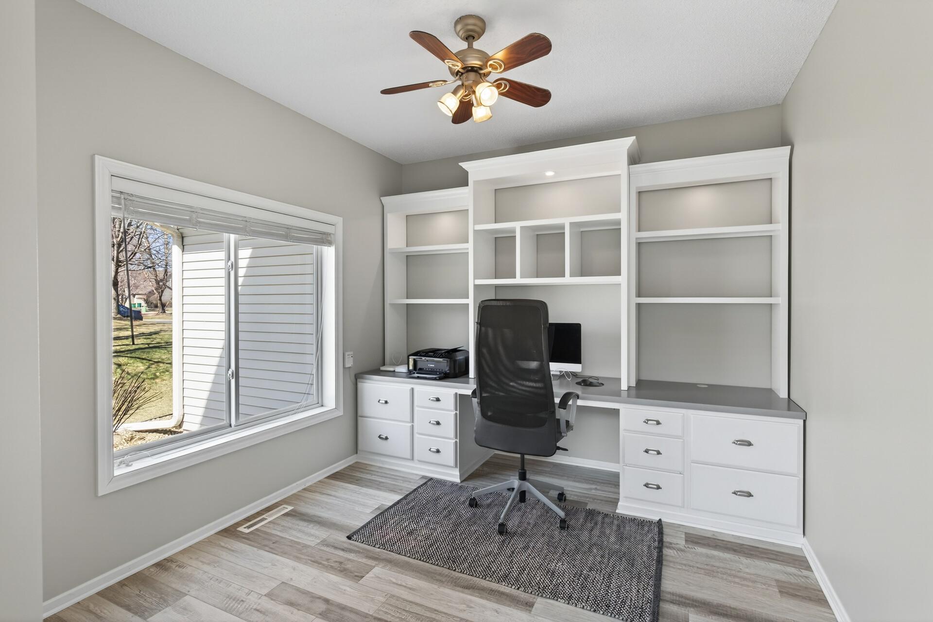 Main level office with a built-in desk.