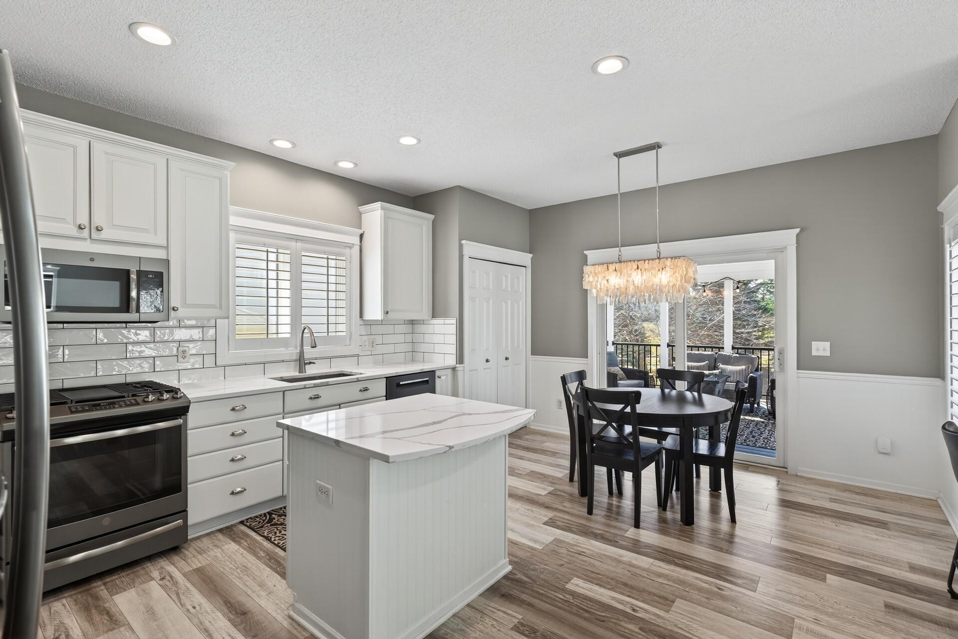 Updated kitchen with quartz counters and backsplash and plenty of seating.