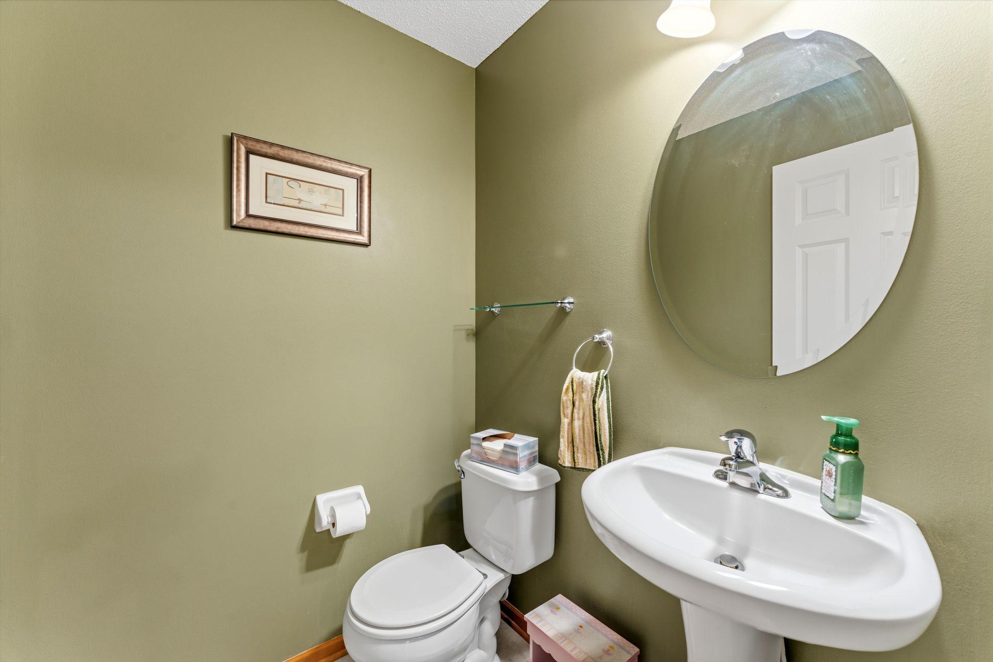 Main floor half bath with clean simple design for guests.