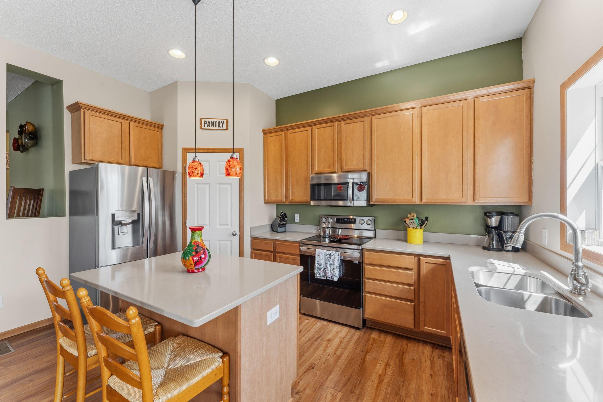 Stylish kitchen featuring center island, stainless steel appliances, and ample cabinetry