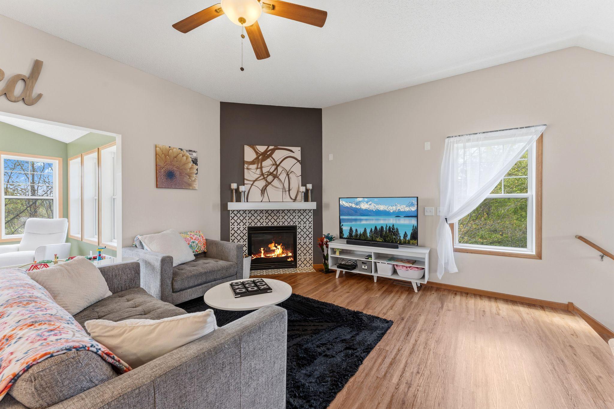 Inviting living room with large windows, and warm, comfortable feel.