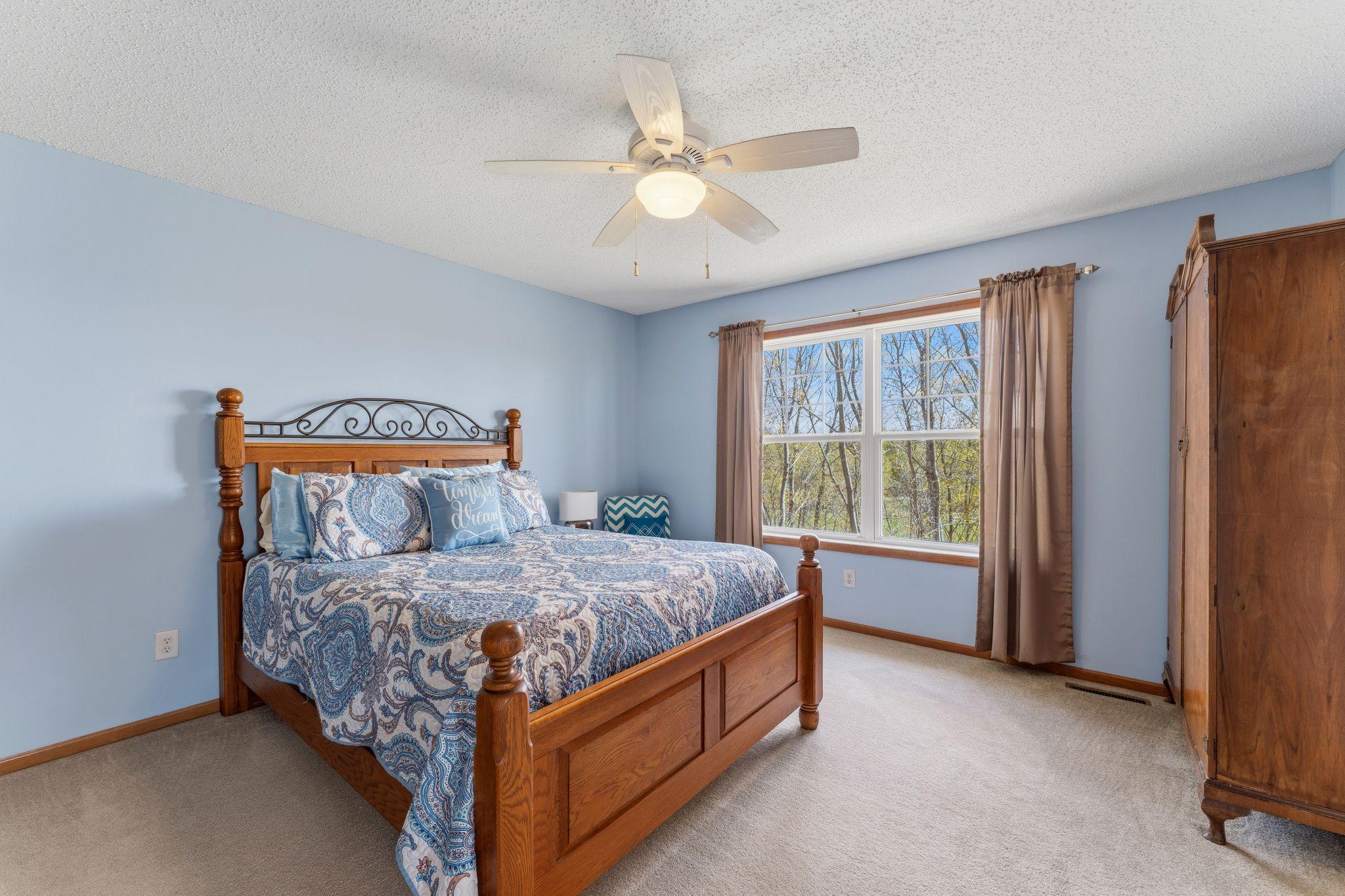 Spacious primary bedroom with soft natural light, neutral finishes, and room to relax and unwind.