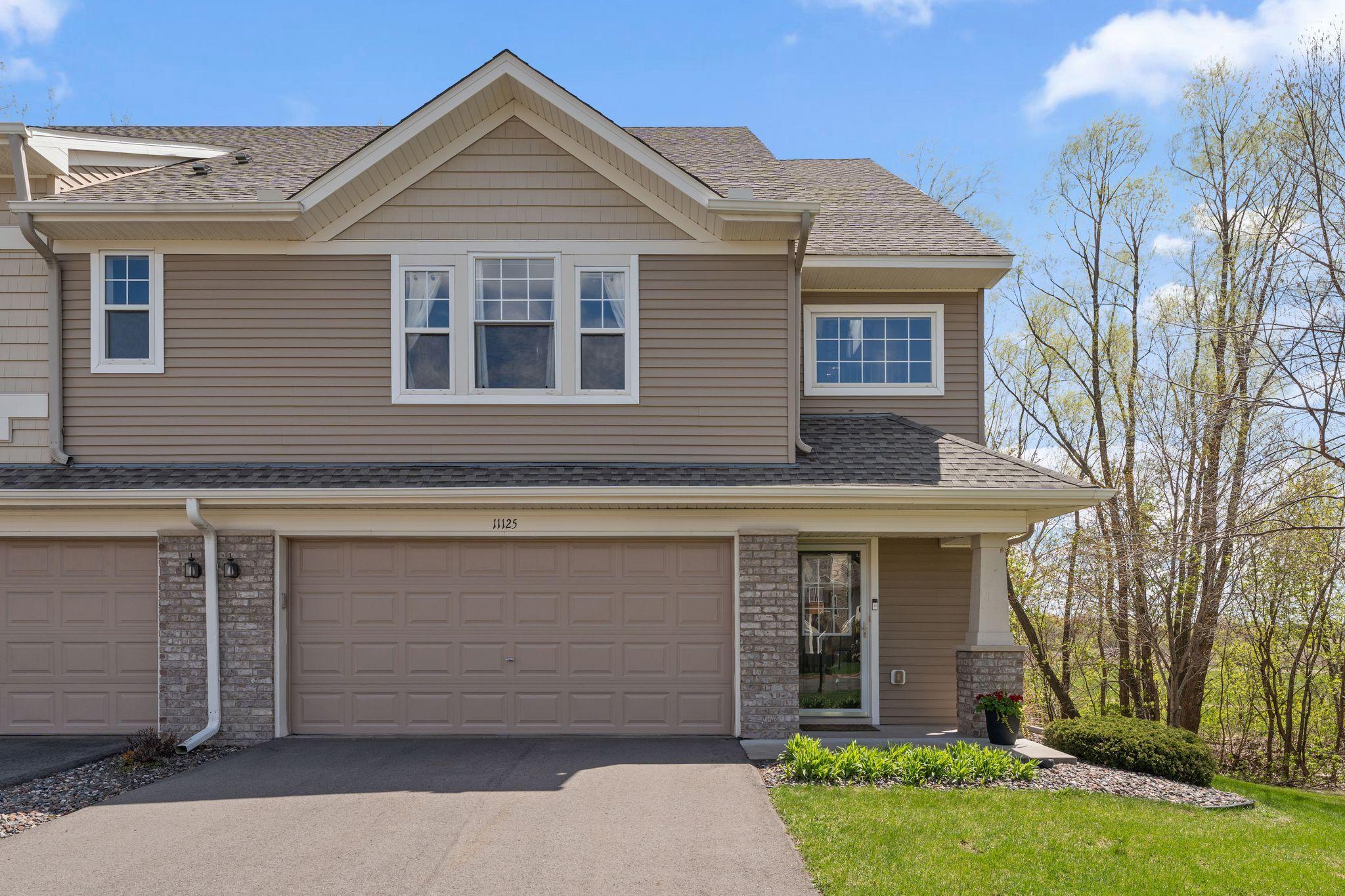 Welcoming front exterior with attached two-car garage and attractive curb appeal.